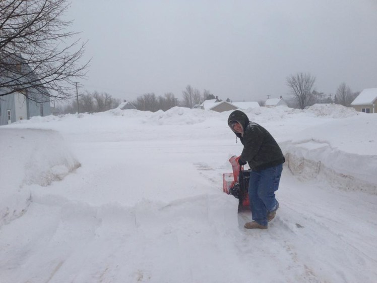 Mike facing the snowdrifts with a smile on his face. 