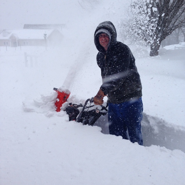 Mike - still smiling even though the snow is reaching beyond the snow blower. 